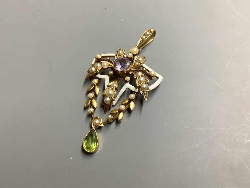 An Edwardian yellow metal stamped 15, amethyst, peridot seed pearl and white enamel set drop pendant, in the suffragette colours